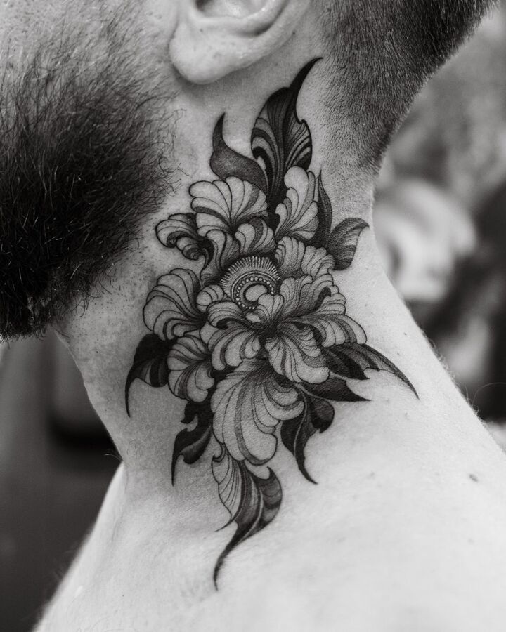 Black and grey peony tattoo on the side of a man's neck