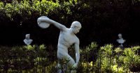 Classical Greek discus thrower statue in a garden