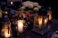 Candle lanterns and flowers placed in remembrance of loved ones