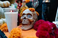 Day of the Dead altar with a decorated skull, marigolds and candles