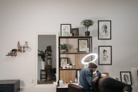 Tattoo artist working on a client in a bright, modern tattoo studio