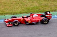 Red Formula 1 car racing on a track